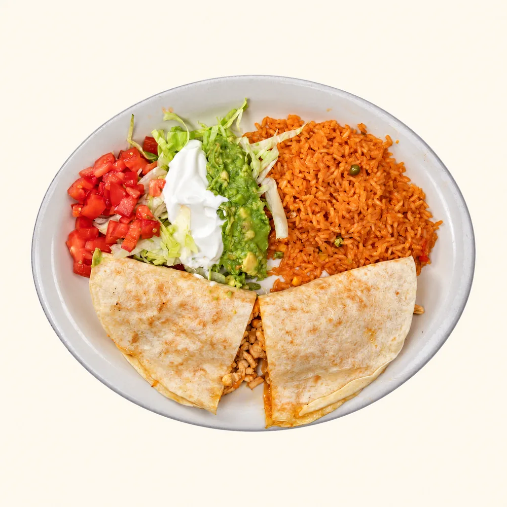 Rey Quesadilla with rice, lettuce, guacamole, sour cream and tomato